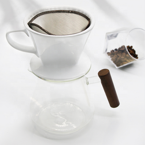 Finmaskigt kaffefilter placerat i en vit bryggtratt över en glaskanna